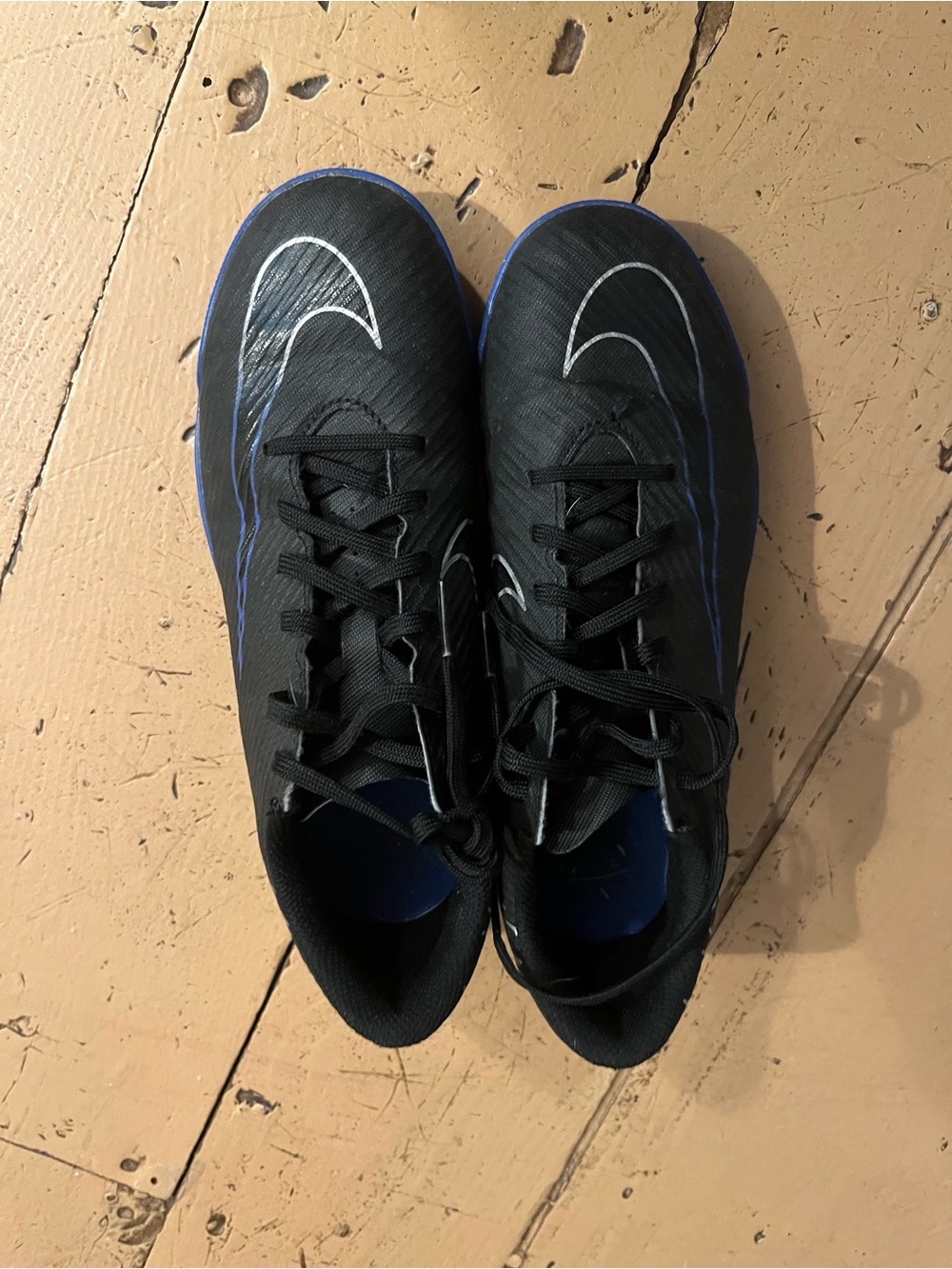 Nike kids Black Cleats with Blue Trim and White Swoosh